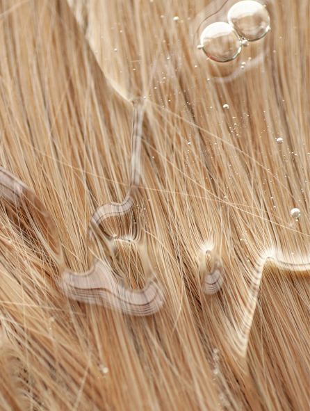 Healthy Blonde Hair With Moisture Droplets Showing Hydrating Benefits Of Keratin Volume Boost Shampoo