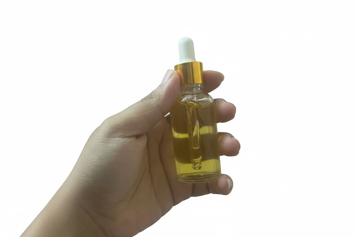 Hand Holding 1oz Yoni Oil Glass Dropper Bottle, Showing Actual Product Size
